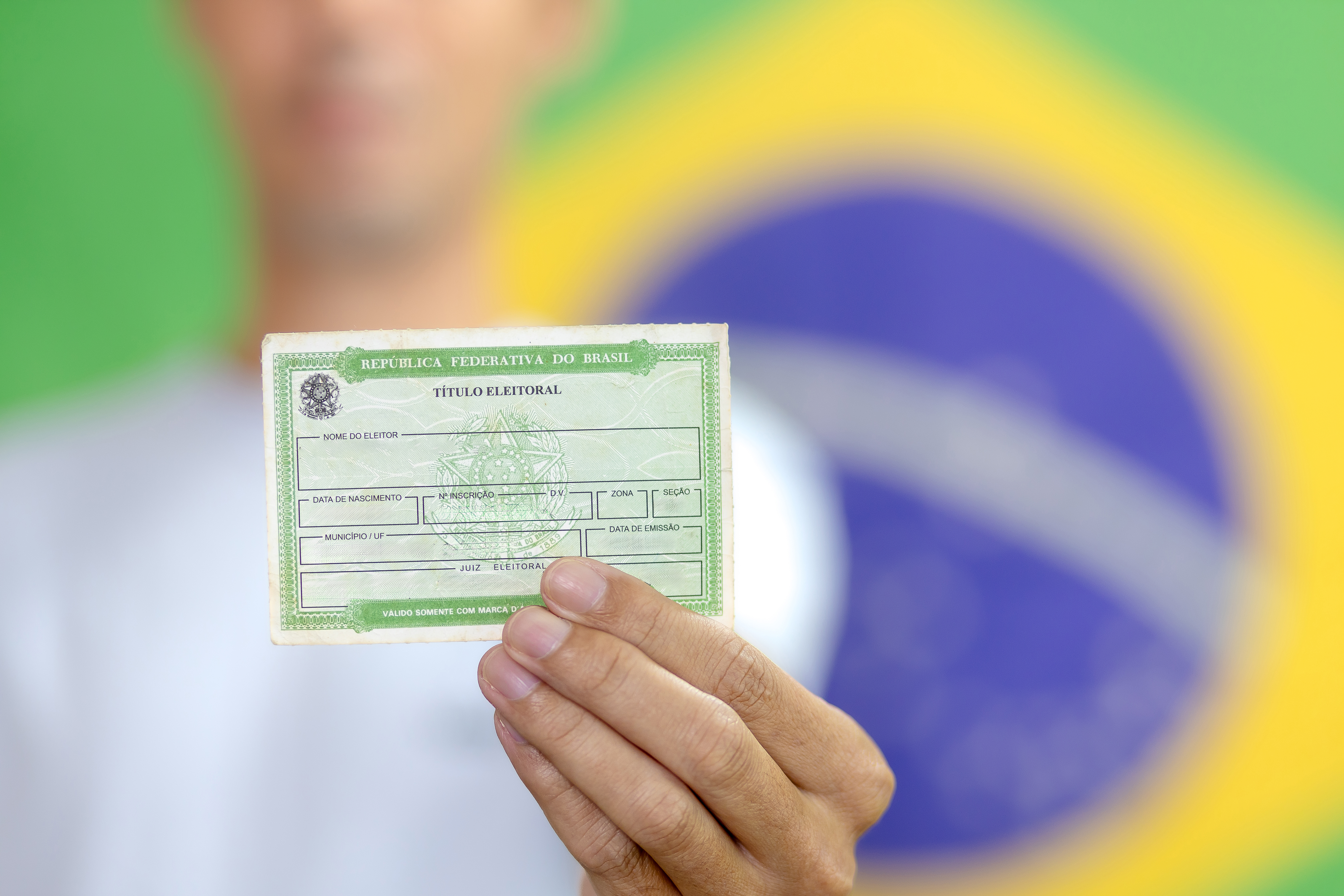 Brazilian voter displaying their voter ID card, an essential document for participating in the national elections. This photograph emphasizes the role of voting in Brazil’s democracy